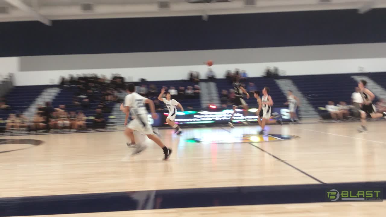 Semaj takes the ball down the court and catches a lucky flip to Anthony to score.