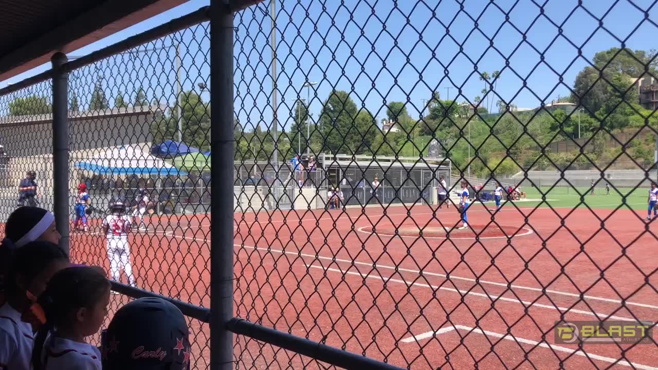 Haylee hits, gets on base and RBI...score to 0-9. Dugout cheers!